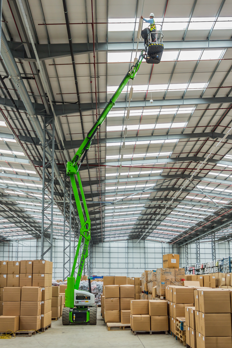 Niftylift HR17N narrow electric cherry picker working in narrow aisle